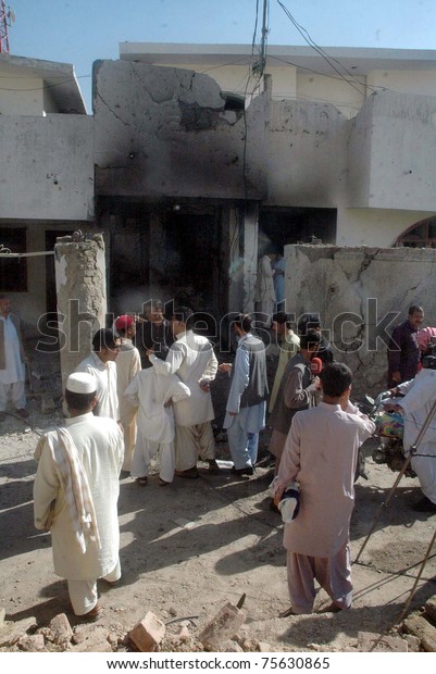 QUETTA, PAKISTAN - APR 19:\
People gather at a damaged building which was destroyed in\
explosion after car bomb explosion at Zarghoon road on April 19,\
2011 in Quetta.