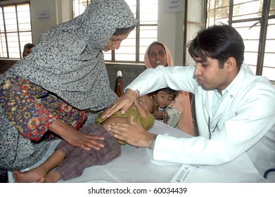 QUETTA, PAKISTAN - AUG 28: A doctor examines patients at a free medical camp for flood affected victims on August 28, 2010 in Quetta. The camp was established by Fatima Foundation Quetta.