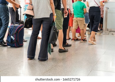 Queue Of Asian People Waiting At Boarding Gate At Airport. Close-up Composition