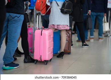 Queue Of Asian People Waiting At Boarding Gate At Airport. Closeup.