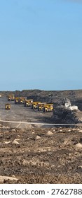 
Queue of mining dump trucks waiting to load over burden on open pit coal mining