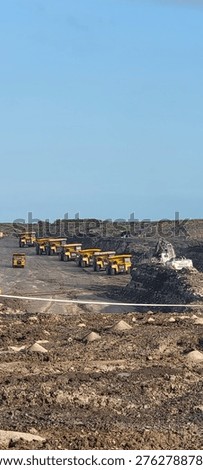 
Queue of mining dump trucks waiting to load over burden on open pit coal mining