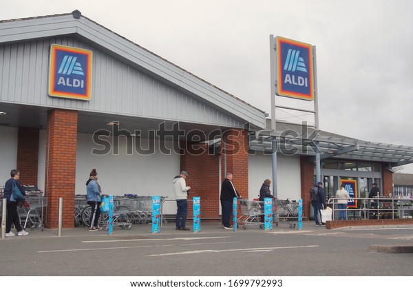A queue of people obeying\
the new social distancing rules outside Aldi supermarket during the\
first COVID 19 lockdown. BOSTON Lincolnshire UK, April 2. 2020\
