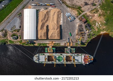 The queue of trucks for loading grain onto the ship. - Shutterstock ID 2172201213