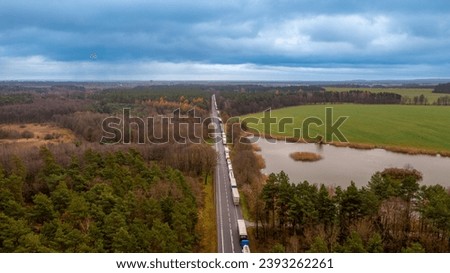 a queue of trucks waiting for border clearance at the road crossing between Poland and Ukraine