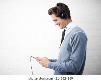 Queuing His Favorite Song. A Young Nerdy Guy Holding An Mp3 Player.