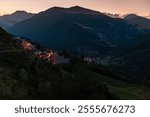 Queyras mountains at sunrise, seen from Meyries village, early departure for day hike, illuminated chalet village and Chateau-Ville-Vieille, Southern French Alps, France