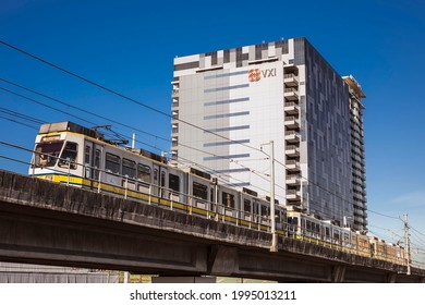 Quezon City, Metro Manila, Philippines - March 2020: An MRT Train Passes By An Office Or Call Center Building Along EDSA