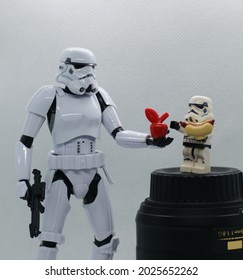 Quezon City, Philippines - Aug 16, 2021: A Star Wars Bandai Stormtrooper figurine offering a trade to a Lego Stormtrooper Minifigure