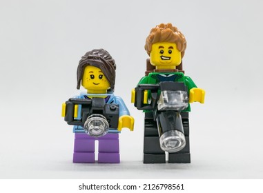 Quezon City, Philippines - February 20, 2022: Lego Child Minifigure Lego Adult Minifigure Posing Together While Holding Cameras