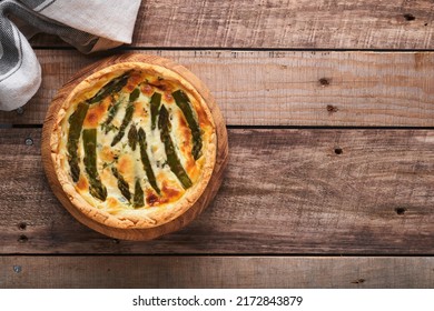 Quiche. Homemade asparagus pie or quiche with cheese and spinach on old wooden table background. Asparagus and cheese tart.  French Quiche. Top view. - Shutterstock ID 2172843879
