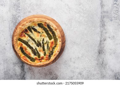 Quiche. Homemade asparagus pie or quiche with cheese, pecorino, bacon and spinach on gray concrete light table background. Asparagus and cheese tart.  French Quiche. Top view. - Shutterstock ID 2175055909