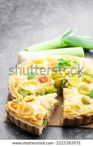 Quiche  with leek and cheese on gray background 