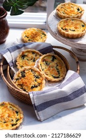 Quiche Lorraine, french pie pastry with striped napkin in rattan basket, selective focus