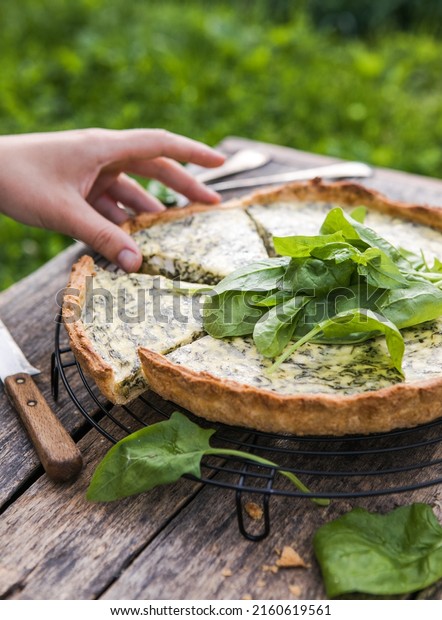 Quiche with spinach - traditional dish of french\
cuisine. Spinach tart