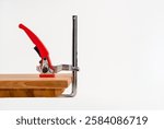 Quick release ratchet MFT table and track saw clamp isolated on a white background with copy space