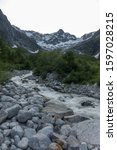 Quick river streams coming down the Alpine valley in the small Swiss village La Fouly in the Swiss Alps, on the Tour de Mont-Blanc trail, Orsieres, Switzerland