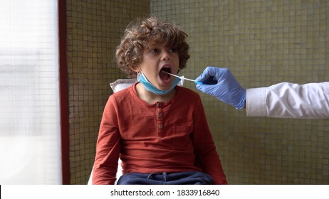 Quick Test For Suspected Coronavirus Diagnosis. Doctor Taking A Nasofaringeal Sample Of A Young Boy, With A Cotton Swab. Covid19 Screening. Child