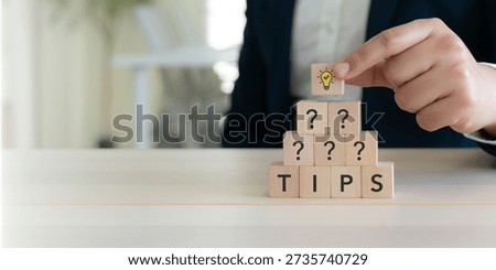 Quick Tips for Smart Solutions. A lightbulb icon block and wooden cubes spelling “TIPS