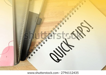 Quick Tips text written on open spiral notebook page. Creative advice, helpful guide, business tutorial, and shortcut concept.