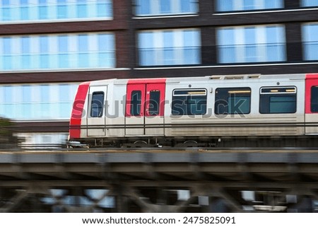 Quickly Speeding Metro Train On Raised Track