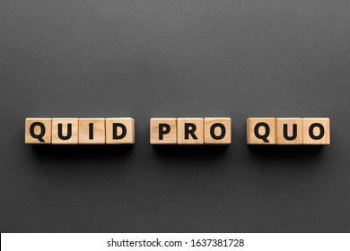 Quid pro quo - words from wooden blocks with letters, 