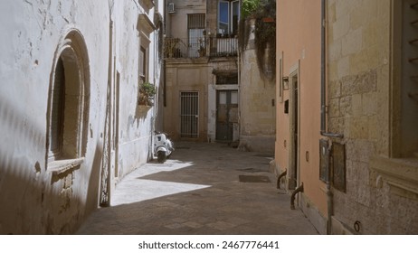 Quiet alleyway in lecce, puglia with old buildings and a parked scooter representing the picturesque, historic charm of this italian town on a sunny day in europe. - Powered by Shutterstock