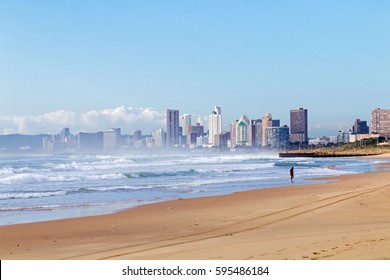 Quiet Early Morning Beach Against Blue Cloudy Sky And City Skyline In Durban, South Africa