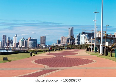 Quiet early morning paved promenade against city skyline and blue cloudy sky in Durban, South Africa