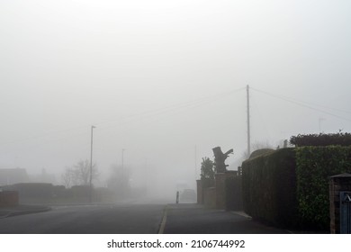 A Quiet Empty Road In A Suburban Town. On A Quiet, Atmospheric Foggy Winters Day. UK