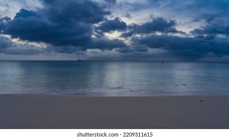 A quiet evening on a tropical beach. The turquoise ocean is calm. Clean smooth sand on the shore. Picturesque blue clouds in the sky. Seychelles. Mahe. Beau Vallon - Shutterstock ID 2209311615