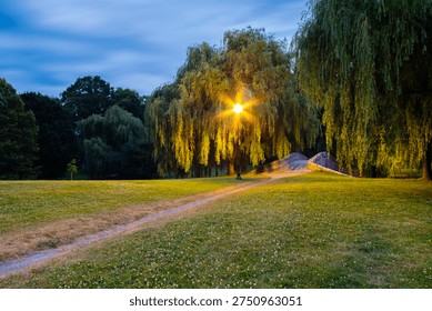 A quiet evening path winds beneath the willows of Upper Onondaga Park, inviting travelers to slow down and discover the softer side of Syracuse