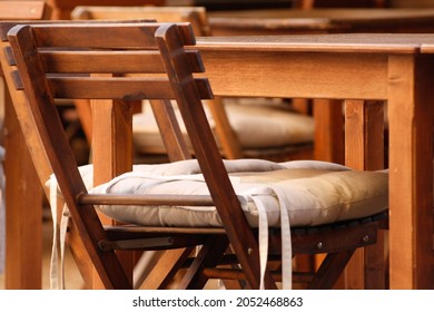 Quiet outside wooden tables and and chairs at a restaurant in Italy, travel holiday relaxation
