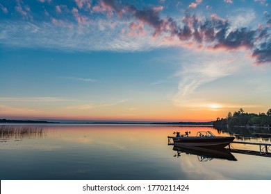 Quiet peaceful fishing boat at the dock at the cottage in Kawartha Lakes Ontario Canada on Balsam Lake - Powered by Shutterstock