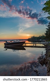 Quiet peaceful fishing boat at the dock at the cottage in Kawartha Lakes Ontario Canada on Balsam Lake