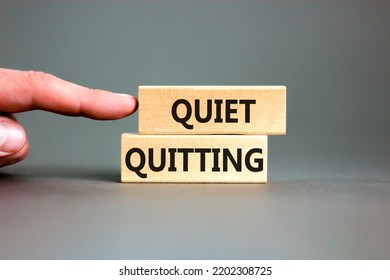 Quiet quitting symbol. Concept words Quiet quitting on wooden blocks. Beautiful grey table grey background. Businessman hand. Business and quiet quitting concept. Copy space. - Shutterstock ID 2202308725