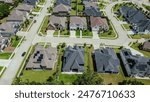 Quiet residential street in upscale new development neighborhood row of expensive two-story houses solar roof panel, Dallas suburbs, sustainable modern Texas custom homes in Flower Mound, aerial. USA