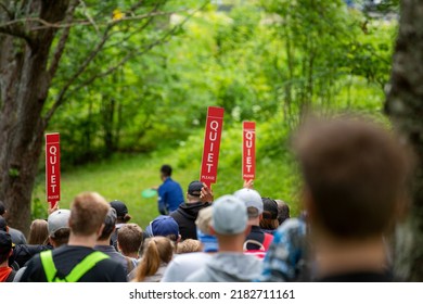 Quiet Sign Shown To The Crowd During Sport Activity, Usually Used In Golf Or Disc Golf Courses.