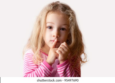 Quiet, Silent Please / Child Girl With A Finger On Her Lips Making A Shush Sign