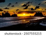 At the Quileute Oceanside Resort in La Push, Washington, looking North along the shore at dusk.  A beautiful bright sunset through a few clouds, and the shoreline rocky bluffs.