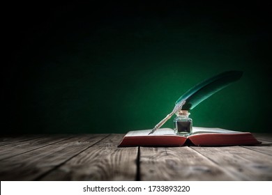 Quill Pen And Inkwell Resting On An Old Book With Green Background Concept For Literature, Writing, Author And History