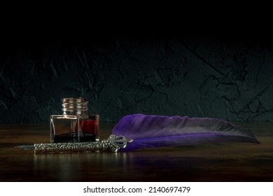 A quill pen with an old inkwell, side view on a black background with a place for text