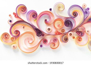 Quilling paper background. Colored strips of paper are rolled and curled for an abstract floral arrangement. Panel from quilling paper in pink and purple tones. Filigree paper hobby.