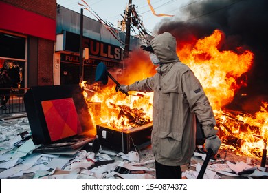 QUILPUE, CHILE - OCTOBER 20, 2019 - Protester poses with part of a uniform looted from a Bank during the protests of the "Evade" movement against the government of Sebastian Pinera