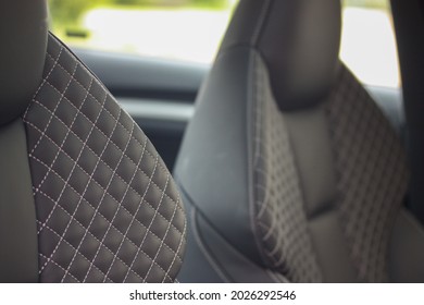 Quilted Diamond Pattern On The Leather Seats Of A Sporty Vehicle