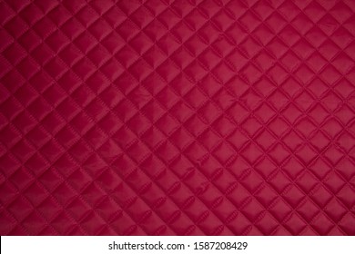 Quilted Fabric. The Texture Of The Blanket.	Red Textile