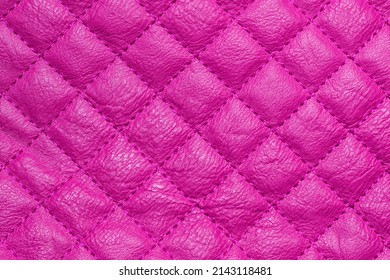 Quilted Fabric Texture. The Repetitive Pattern Of Leather With Pink Diamond Stitching