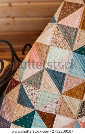 Quilted patchwork quilt closeup. Vertical