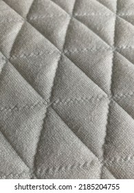 Quilted Pillow With Geometric Triangle Pattern