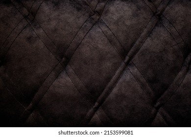 Quilted velour buttoned classic black color fabric wall pattern background. Elegant vintage luxury sofa upholstery. Interior plush backdrop.